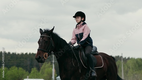 A Young Equestrian Riding a Horse in a Beautiful and Scenic Landscape Setting Outdoors