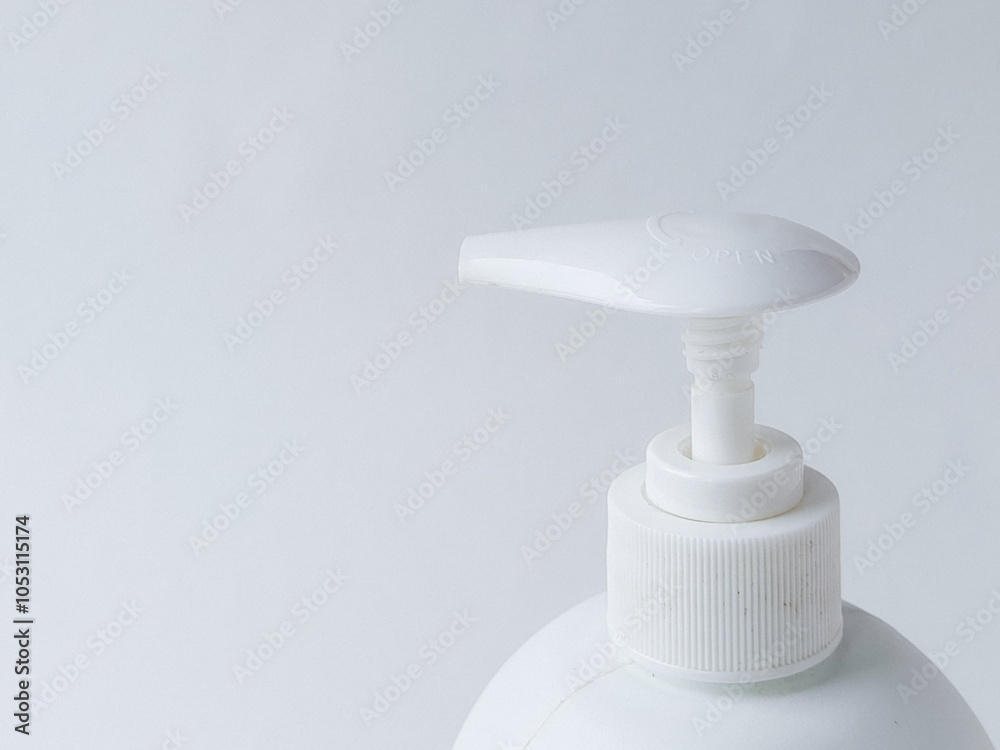 Dispenser on white bottle of liquid soap, shampoo, gel, foam on white background. Background. Space for text. Dispenser on white bottle of liquid soap, shampoo, gel, foam on white background. Background. Space for text.