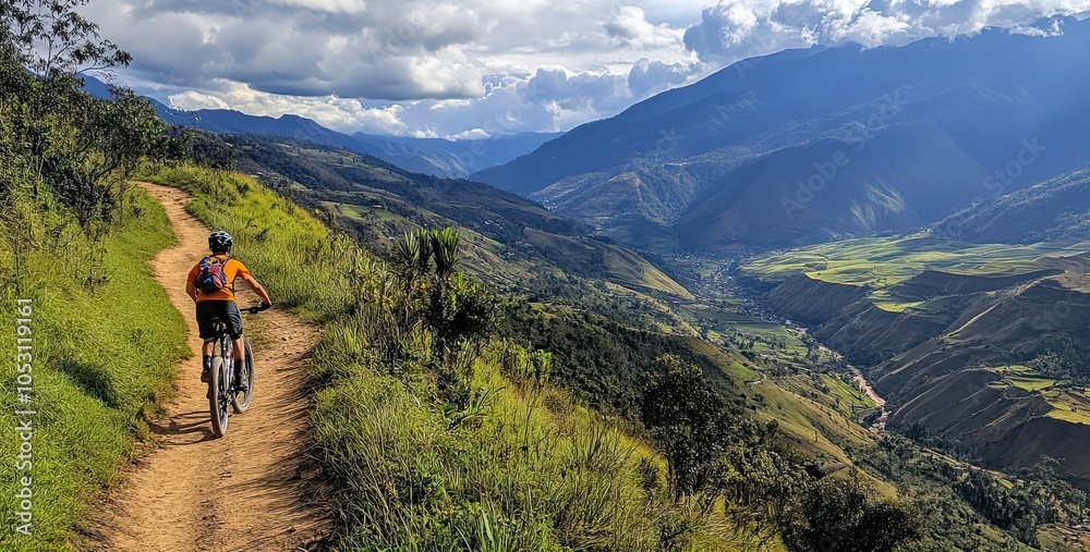 Mountain Biker Ascending a Dirt Path with Scenic Valley View Mountain Biker Ascending a Dirt Path with Scenic Valley View