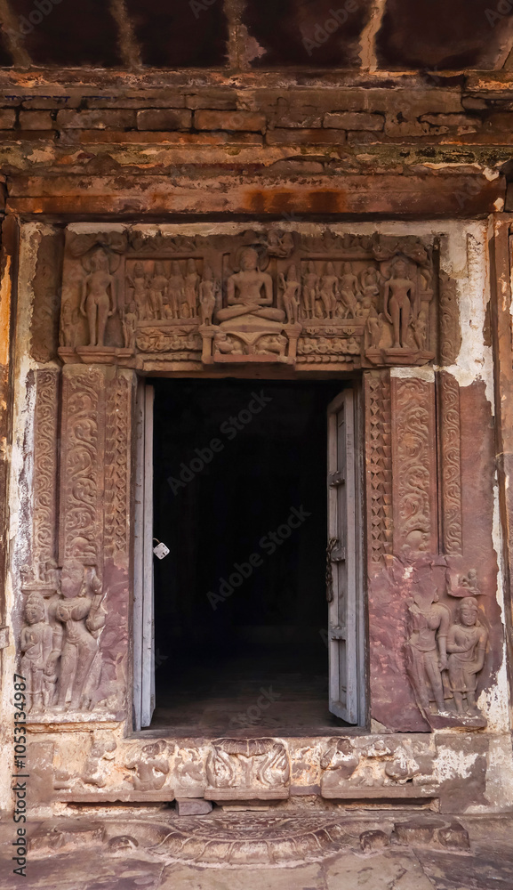 Carved entrance of the Jain Temple adorned with sculptures of deities, located in Budhi Chanderi, Madhya Pradesh, India. Carved entrance of the Jain Temple adorned with sculptures of deities, located in Budhi Chanderi, Madhya Pradesh, India.