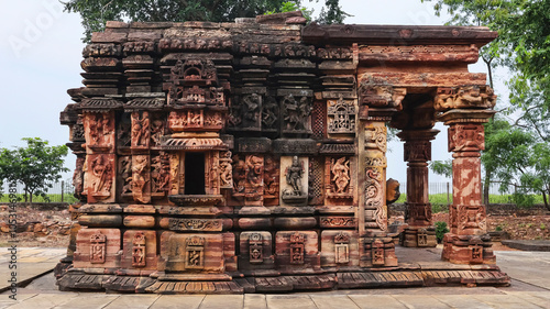 View of the carved Mohajmata Temple, a 9th-10th century monument built under the Kalachuri King, located in Terai, Shivpuri, Madhya Pradesh, India. photo