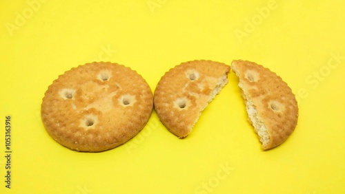 Split round coconut biscuits, cracked round biscuits, isolated yellow background. Coconut biscuits, coconut cookies