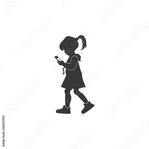 Silhouette of a young girl walking and using a smartphone