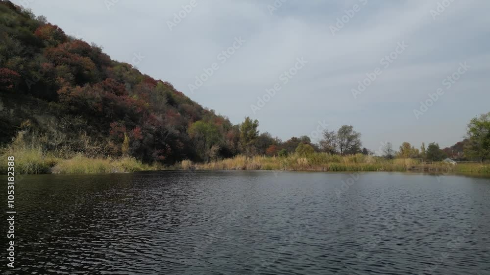 Pond. A mountainous area with different vegetation. Autumn time.