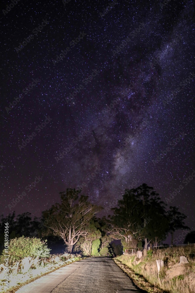 Fototapeta premium Milky Way over a rural road at night