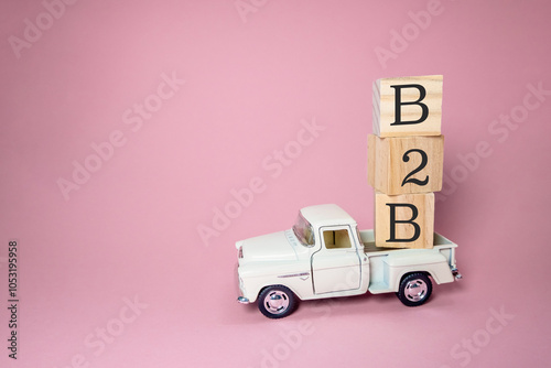 A white truck is carrying a stack of wooden blocks photo