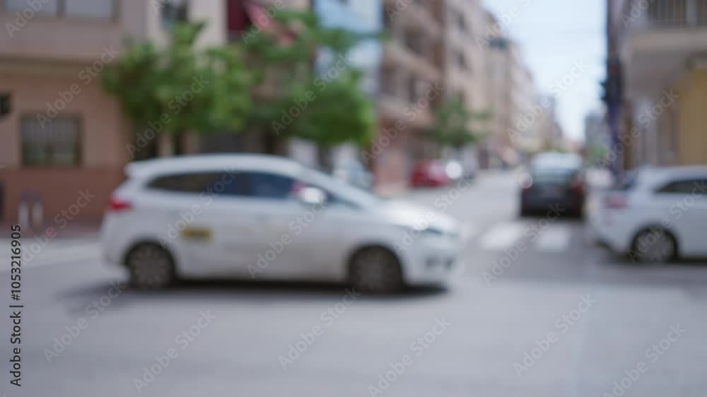 Blurred city street scene with out-of-focus cars and buildings showcasing urban life in an outdoor town environment with bokeh effect and bright daylight Blurred city street scene with out-of-focus cars and buildings showcasing urban life in an outdoor town environment with bokeh effect and bright daylight