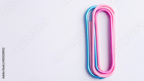 Pastel Paperclips: A minimalist composition featuring three paperclips in vibrant pastel hues. The image is set against a crisp white background.