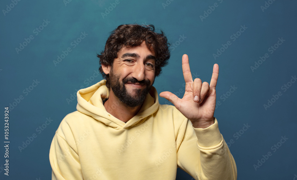 feeling happy, fun, confident, positive and rebellious, making rock or heavy metal sign with hand feeling happy, fun, confident, positive and rebellious, making rock or heavy metal sign with hand