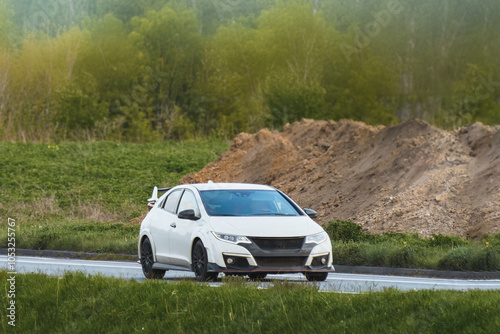 Silver Japanese Sports Car With Spoiler Racing on Rural Road