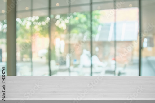 Wooden top table with abstract blur interior coffee shop or cafe for background. Restaurant interior banner, Hospital and clinic blurry. Blurred windows green on outdoor and view of light living room. photo