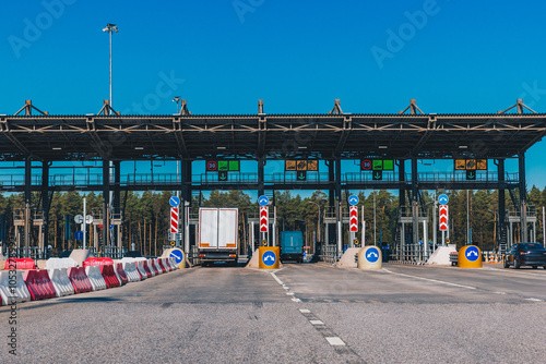 Toll station. Сrossing toll road gates at sunny summer day