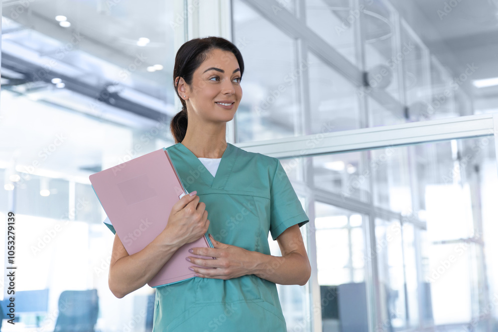 Pretty smiling young woman in lab coat looking contented Pretty smiling young woman in lab coat looking contented