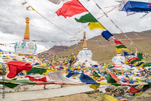  Stupas of kunzum pass at 4,590 m is a high mountain pass on kunzum range of the himalayas. View of Prayer flags with stupas Kunzum Pass at spiti, Himachal Pradesh, India. photo