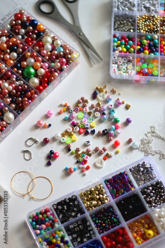 Obraz na płótnie Colorful beads, letter beads, threads and other jewelry making supplies on white background. Making friendship bracelets concept. Selective focus. w salonie