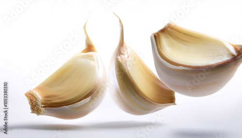 garlic slices or chunks floating or flying isolated white background