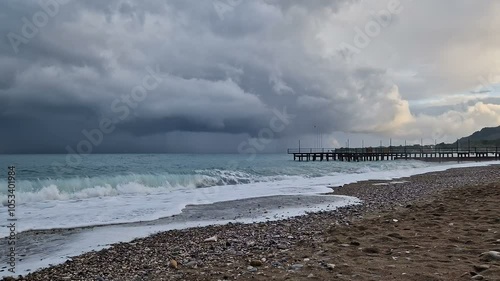 The sea before the rain, big waves, windy weather, cold, cloudy sky.