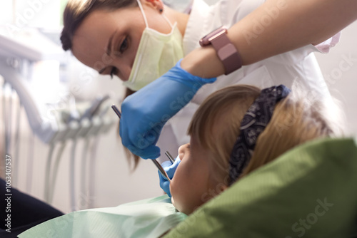 Dentist doctor lady having exam teeth child in dental clinic office, lifestyle photo. Child girl patient visit dentist woman for examining teeth. Medical children dentistry concept. Copy ad text space photo