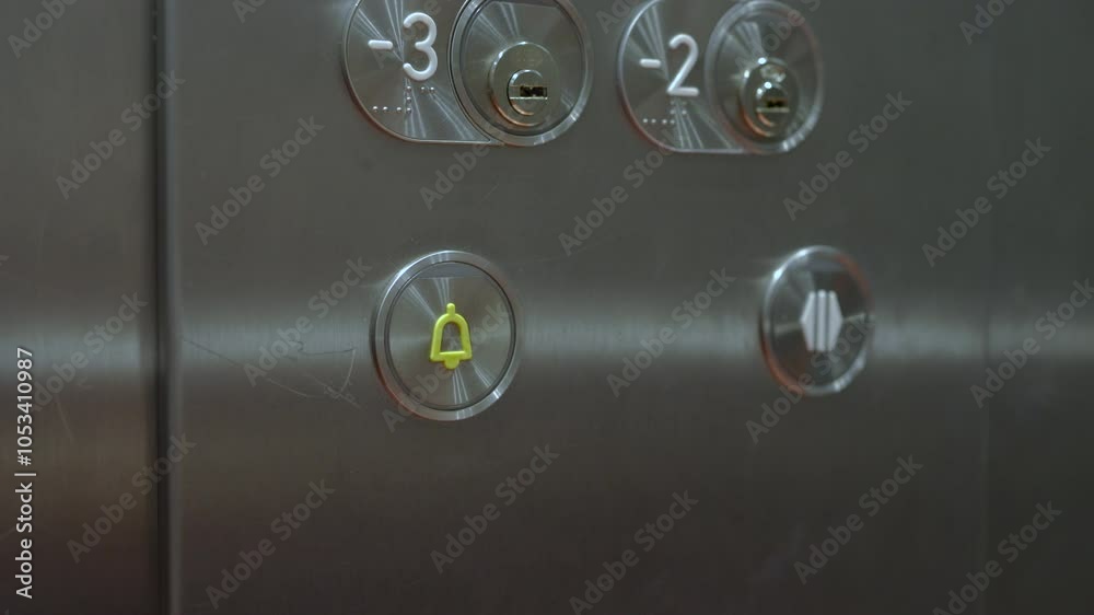 Closeup of hand pressing the alarm button in the elevator
