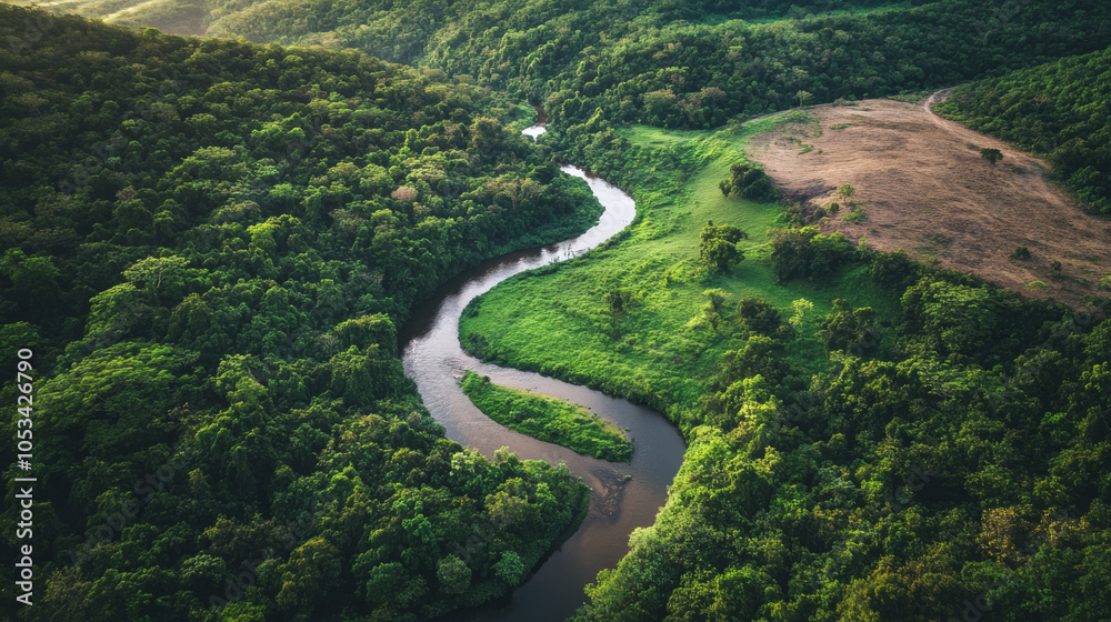 Overhead shot of a winding river creating a natural divide between two contrasting landscapes, one green and lush, the other dry and barren. Overhead shot of a winding river creating a natural divide between two contrasting landscapes, one green and lush, the other dry and barren.