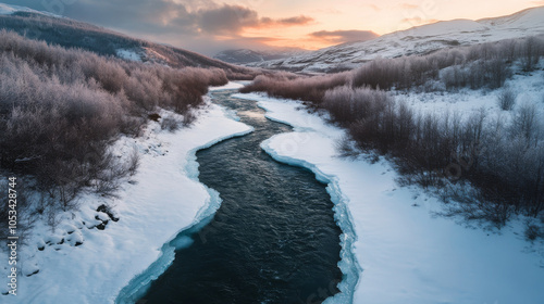 Wallpaper Mural Aerial view of a river meandering through a tranquil, snow-covered landscape, featuring frozen waters and white-capped banks that create a peaceful winter scene. Torontodigital.ca