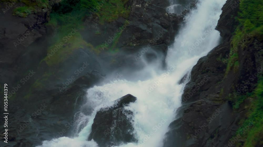 Latefossen waterfall, scenic cascade in Norway. Idyllic Scandinavia nature, lush green landscape.