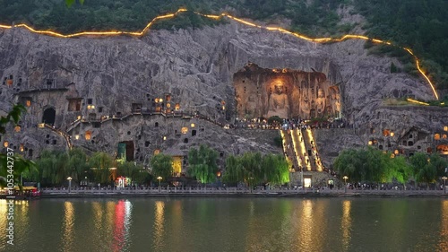 Luoyang, China: Evening view of the famous Vairocana Buddha statue and the multiples caves in the Luoyang Longmen Grottoes along the Yi river in China.