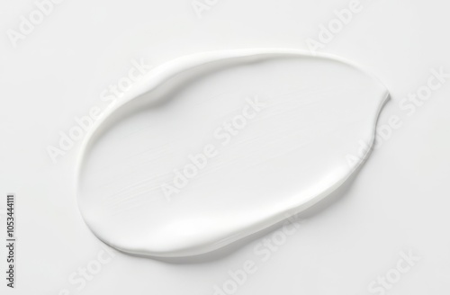 A large smear of white cosmetic product on a white background. photo