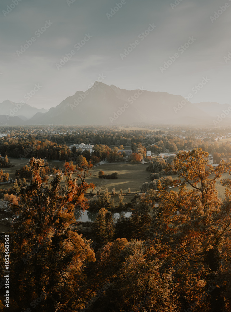 Beautiful panoramic view of yellow fall scenery in Salzburg with Untersberg mountain in golden evening light at sunset, Austria