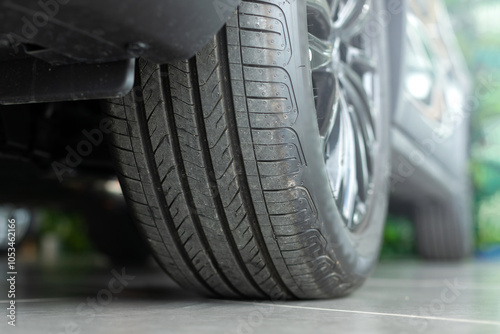 A car tire tread, highlighting the importance of inspecting wheels and tire condition before travel. Emphasizes road safety and vehicle readiness for the journey ahead