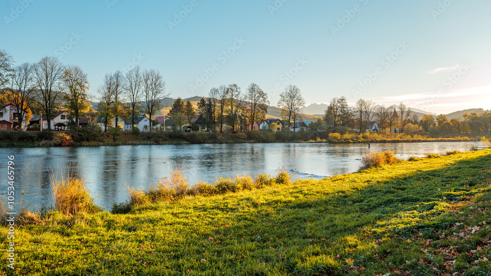 The grassy bank of the Dunajec River. Beautiful autumn. Golden hour. View towards the Tatra Mountains. Sromowce Niżne. View towards Slovakia.