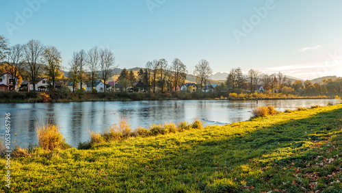 Obraz na płótnie The grassy bank of the Dunajec River. Beautiful autumn. Golden hour. View towards the Tatra Mountains. Sromowce Niżne. View towards Slovakia. w salonie