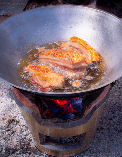 Crispy pork in a pan with hot oil. Crispy fried food. Deep-fried food. High-fat food.