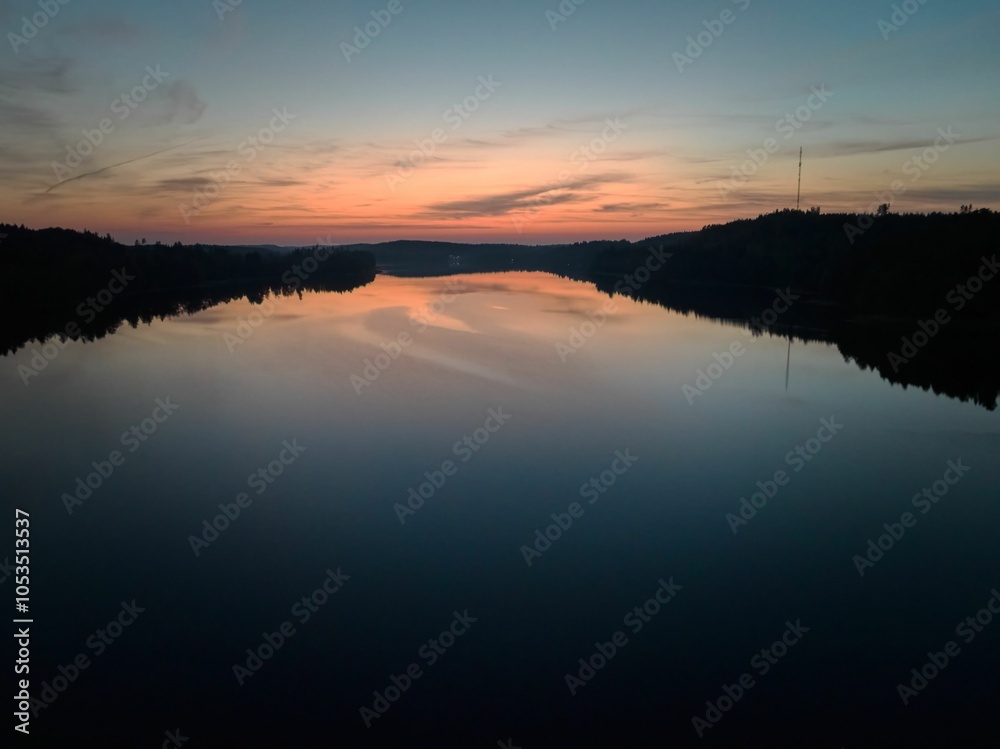 Sunset over a tranquil river reflecting vibrant hues. Sunset over a tranquil river reflecting vibrant hues.