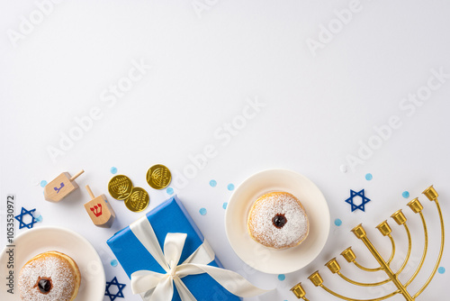 Festive Hanukkah setup featuring a menorah, dreidels, coins, and gifts. Two sufganiyah donuts add to the joyful holiday atmosphere, with blue decorations symbolizing the celebration photo