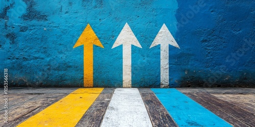 Colorful arrows ascending from a wooden surface against a blue wall, vibrant yellow, blue, and white hues creating a dynamic visual contrast photo