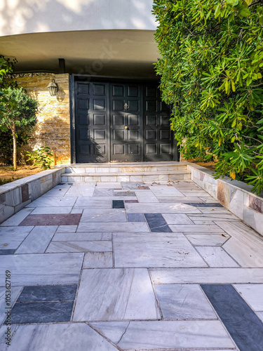 The external main entrance wooden door of a luxury classic design apartment building. Travel to Athens, Greece.