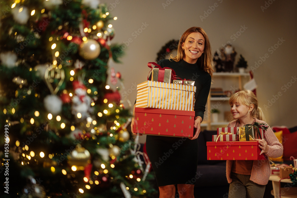 © bernardbodo - Happy mother and daughter carrying a lot of presents © bernardbodo - Happy mother and daughter carrying a lot of presents