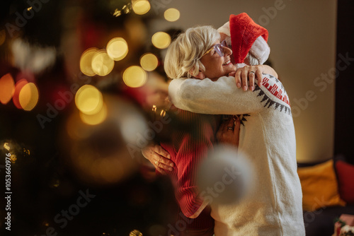 Grandpa wearing Santa hat and hugging his wife