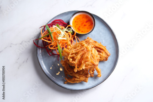 Deep fried enoki mushrooms served with salad crunch and sweet chili sauce.