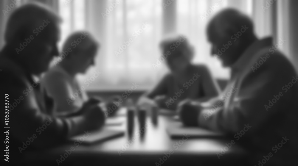 Fototapeta premium A group of elderly people sitting at a table in a nursing home playing board games