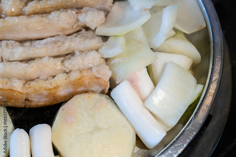 roasting pork intestines with onion, potato, chives, lung and potato on the pan roasting pork intestines with onion, potato, chives, lung and potato on the pan