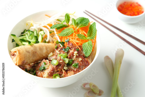 Bun Cha Gio bowl topped with meat slices and fried spring roll. photo