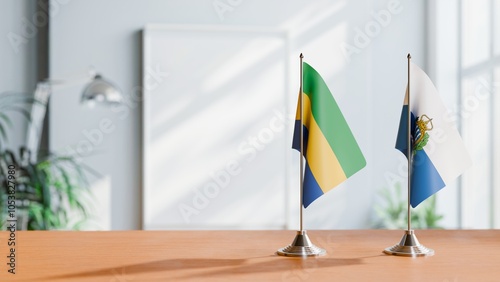 FLAGS OF GABON AND SAN MARINO ON TABLE photo