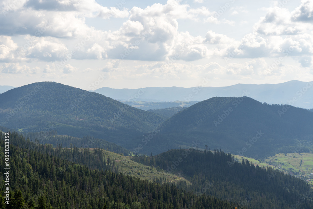 Mountains ranges in the Carpathians. Hills, forest and meadows. Green blue valley. Village Ukraine Mountains ranges in the Carpathians. Hills, forest and meadows. Green blue valley. Village Ukraine