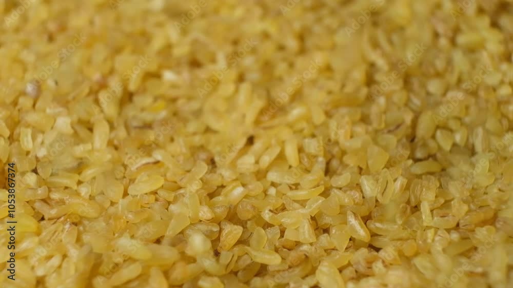Uncooked bulgur cracked wheat pour. macro slow motion Uncooked bulgur cracked wheat pour. macro slow motion