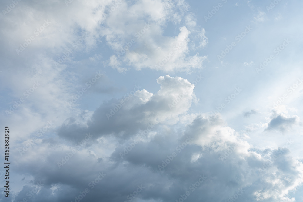 Fluffy white clouds drift across a vast expanse of blue sky Fluffy white clouds drift across a vast expanse of blue sky