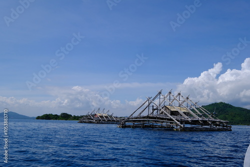 floating cages in the open sea. fish farming in the middle of the sea. nets in the sea. 
