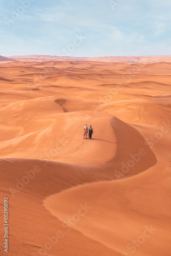 Fototapeta Naklejka Na Ścianę i Meble -  Woman posing background red dunes of Saudi Arabia