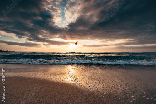 Beautiful sunrise over the sea waves and tropical beach